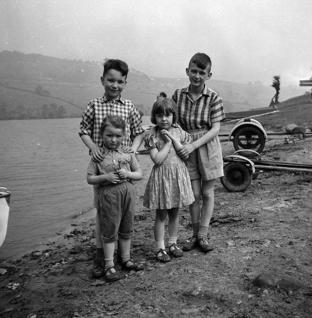 Beside Rudyard Lake, with Mike on the right, and Geoff and Sue on the left. We have no idea who the other little girl is, next to Mike.